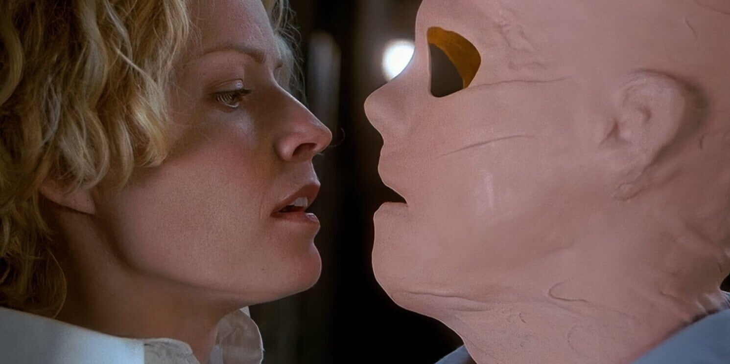 Hollow Man (2000) An Invisible Kevin Bacon, wearing a crudely made latex mask with no visible eyes stares threateningly at scared but calm Elisabeth Shue