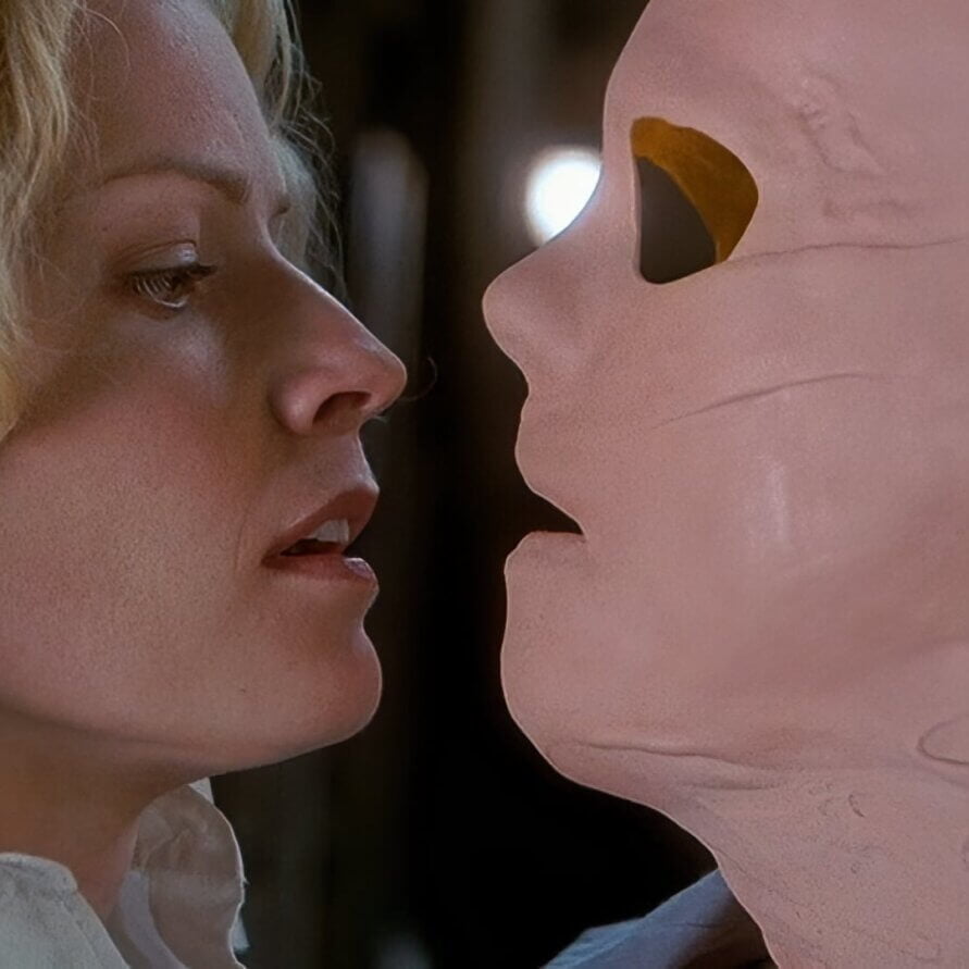 Hollow Man (2000) An Invisible Kevin Bacon, wearing a crudely made latex mask with no visible eyes stares threateningly at scared but calm Elisabeth Shue