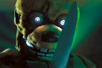 Five Nights At Freddy's (2023) An Evil Yellow Animatronic Rabbit with Glowing Robot Eyes Wields A Giant Sharp Butcher's Knife While Grinning Menacingly Under Green Arcade Lighting