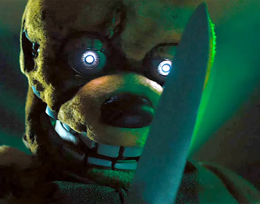 Five Nights At Freddy's (2023) An Evil Yellow Animatronic Rabbit with Glowing Robot Eyes Wields A Giant Sharp Butcher's Knife While Grinning Menacingly Under Green Arcade Lighting