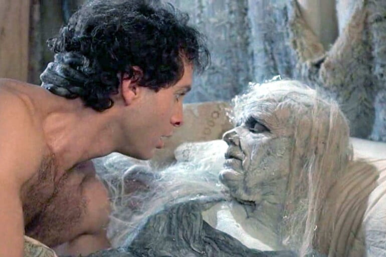 High Spirits (1988) Shirtless and Scared, Steve Guttenberg stares in horror at the aged ghost of Daryl Hannah underneath him in bed.