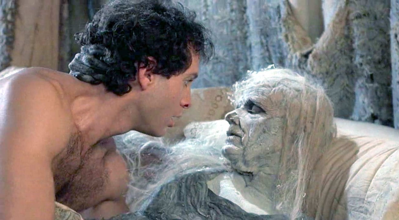 High Spirits (1988) Shirtless and Scared, Steve Guttenberg stares in horror at the aged ghost of Daryl Hannah underneath him in bed.