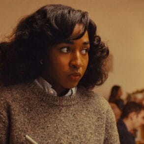 Opus (2025) Ayo Edebiri Looks around, nervously taking notes during a strange dinner party
