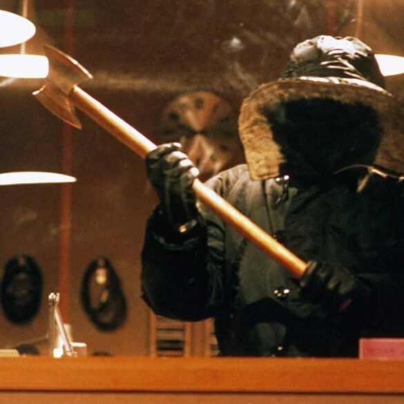 Urban Legend (1998) - The Killer Stalks in The Univerisity Radio Statio,, wearing a snow jacket that obscures their identity, wielding an axe