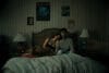 Inde Navarrette stars as Nikki and Michael Johnston as Bear in OBSESSION, a Focus Features release. Nikki and Bear Sitting next to each other in Bed